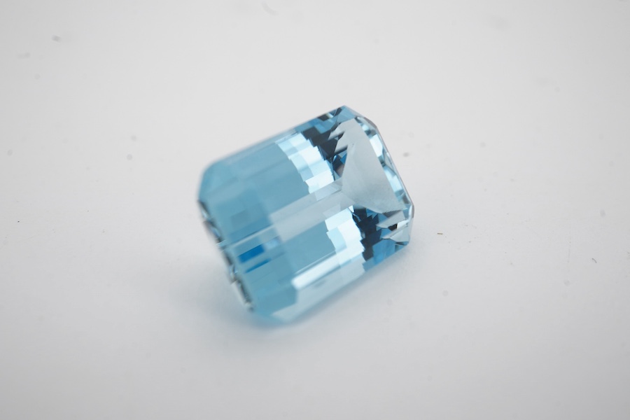 An unmounted emerald cut aquamarine, weighing approximately 6.00ct, in a fitted gilt tooled leather box by Francelino Horta Junior, Rio De Janeiro. Condition - fair to good